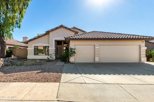 a view of a house with a yard and garage