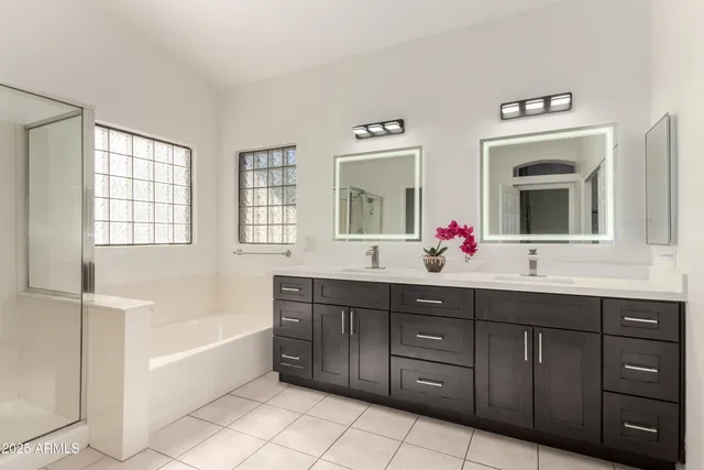 a bathroom with a tub sink and mirror