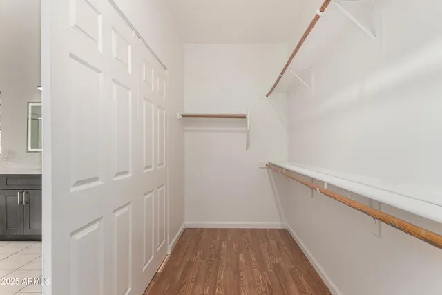 a view of a hallway with wooden floor and entryway