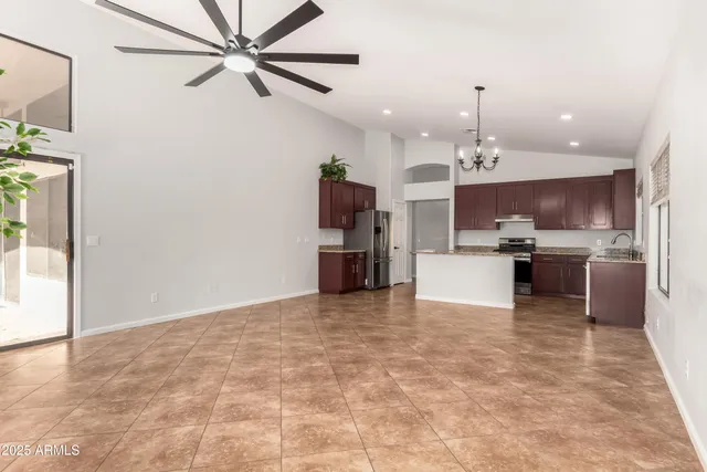 a view of a kitchen with a sink and a refrigerator