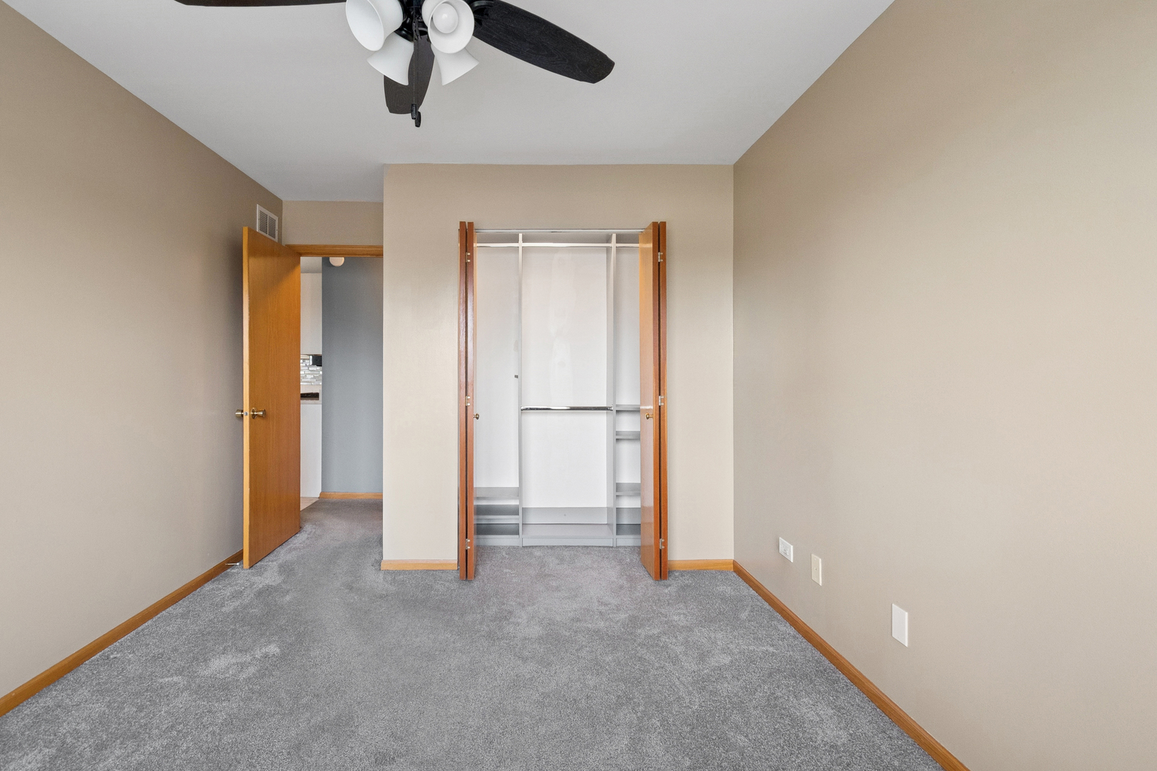 5356 Dixie Drive, Unit 5356 Alsip, IL 60803 - Photo 9 of 20 an empty room with ceiling fan and window