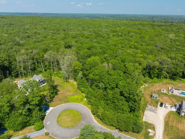 a aerial view of a residential houses with yard