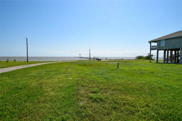 a backyard of a house with lots of green space and outdoor seating