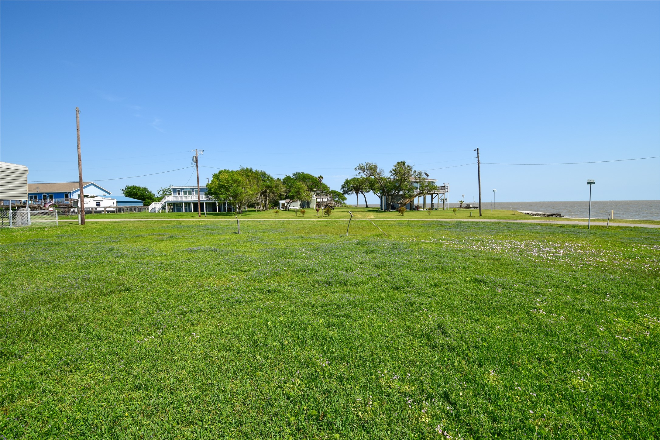 0 James Street Anahuac, TX 77514 - Photo 14 of 35 a backyard of a house with lots of green space and outdoor seating