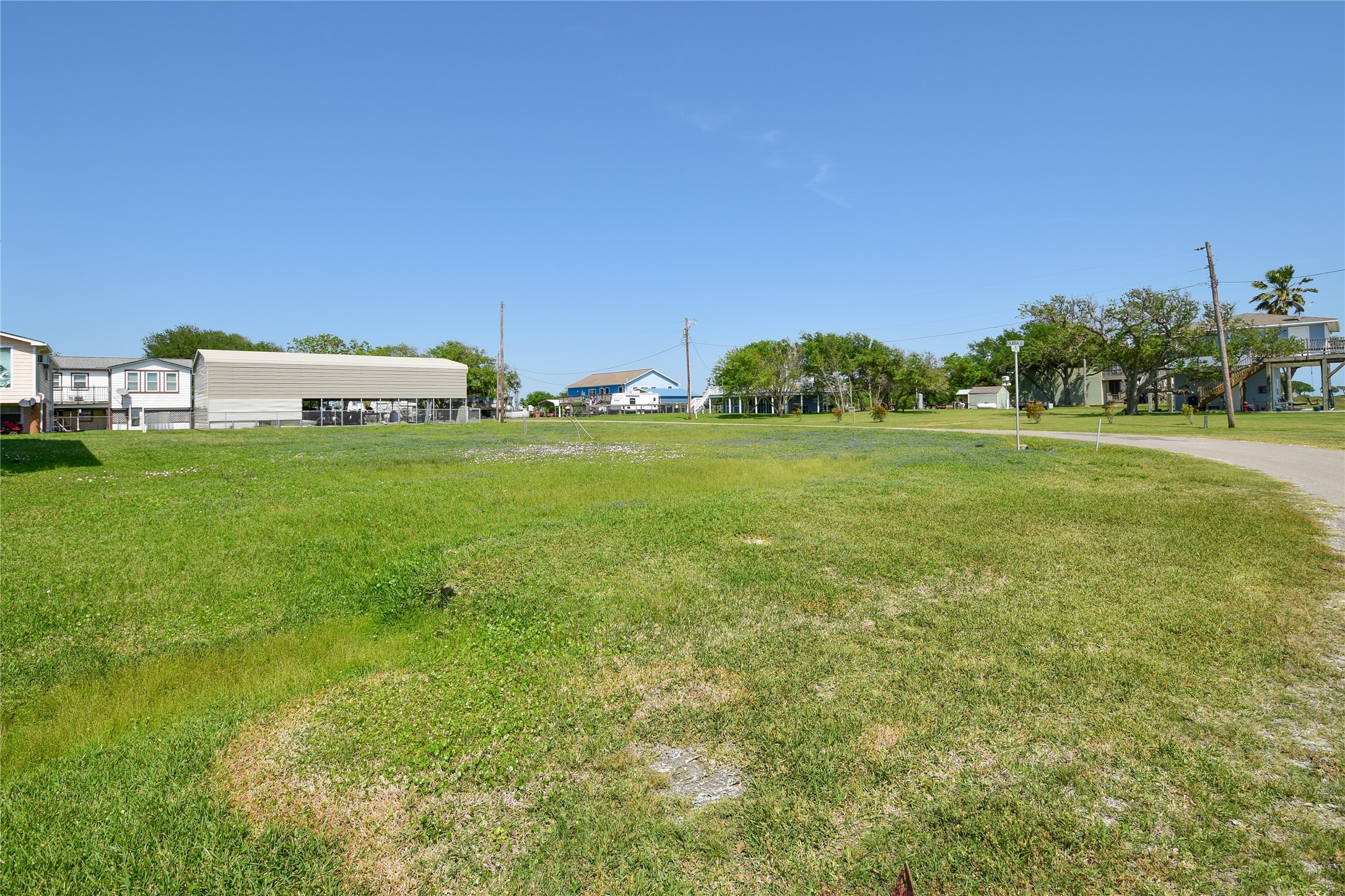 0 James Street Anahuac, TX 77514 - Photo 4 of 35 a view of a big yard with a house in the background