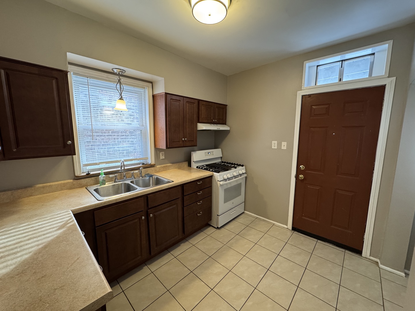 6840 South Champlain Avenue, Unit 2 Chicago, IL 60637 - Photo 5 of 12 a kitchen with a sink a stove top oven and wooden floor