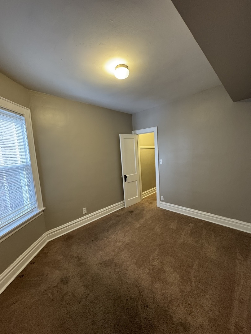 6840 South Champlain Avenue, Unit 2 Chicago, IL 60637 - Photo 9 of 12 an empty room with windows