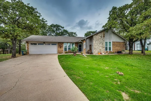 a front view of house with yard and green space