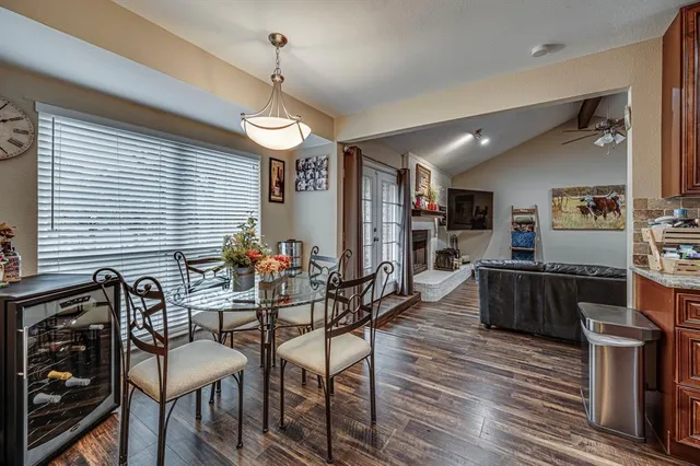 a dinning area with furniture and wooden floor