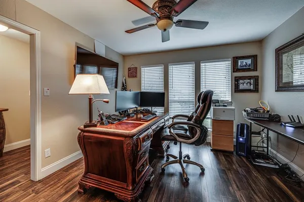 a view of a workspace with furniture and a window