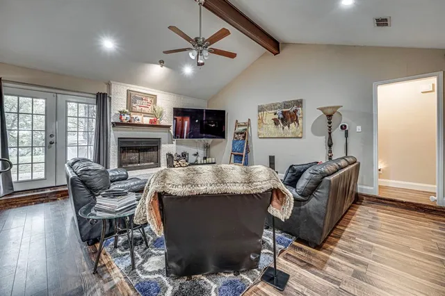 a living room with furniture fireplace and window