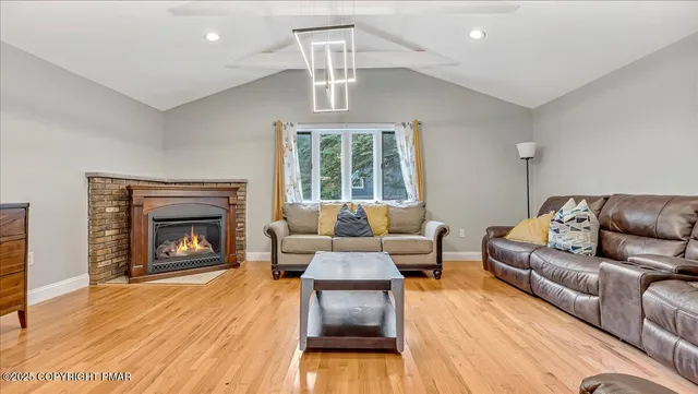 a view of a kitchen with kitchen island a counter top space a sink and appliances