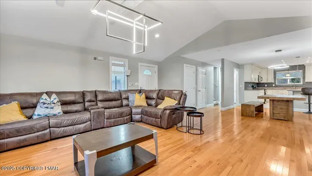 a kitchen with stainless steel appliances granite countertop a sink and a refrigerator