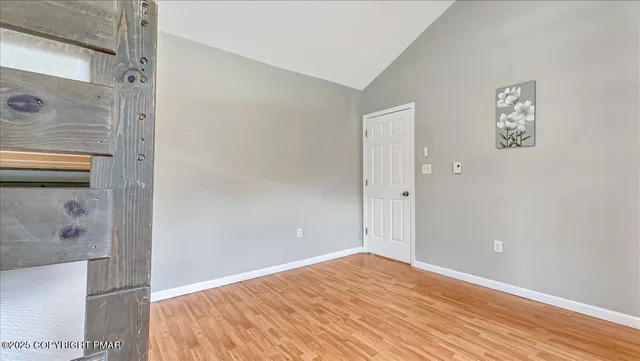 a view of a kitchen with wooden floor and staircase