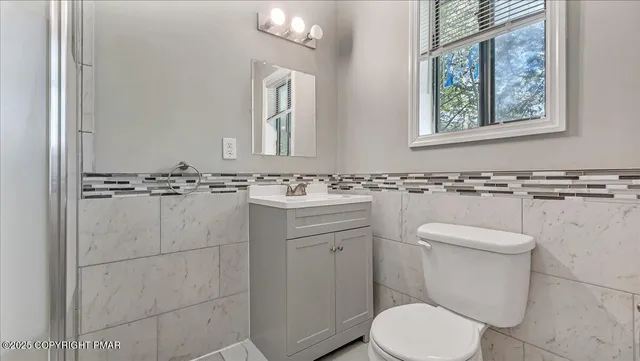 a front view of a house with a tree