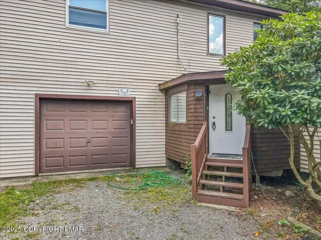a view of a house with backyard and trees