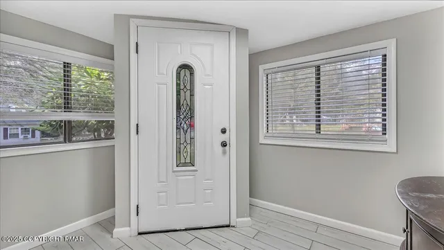 a living room with furniture a fireplace and a large window