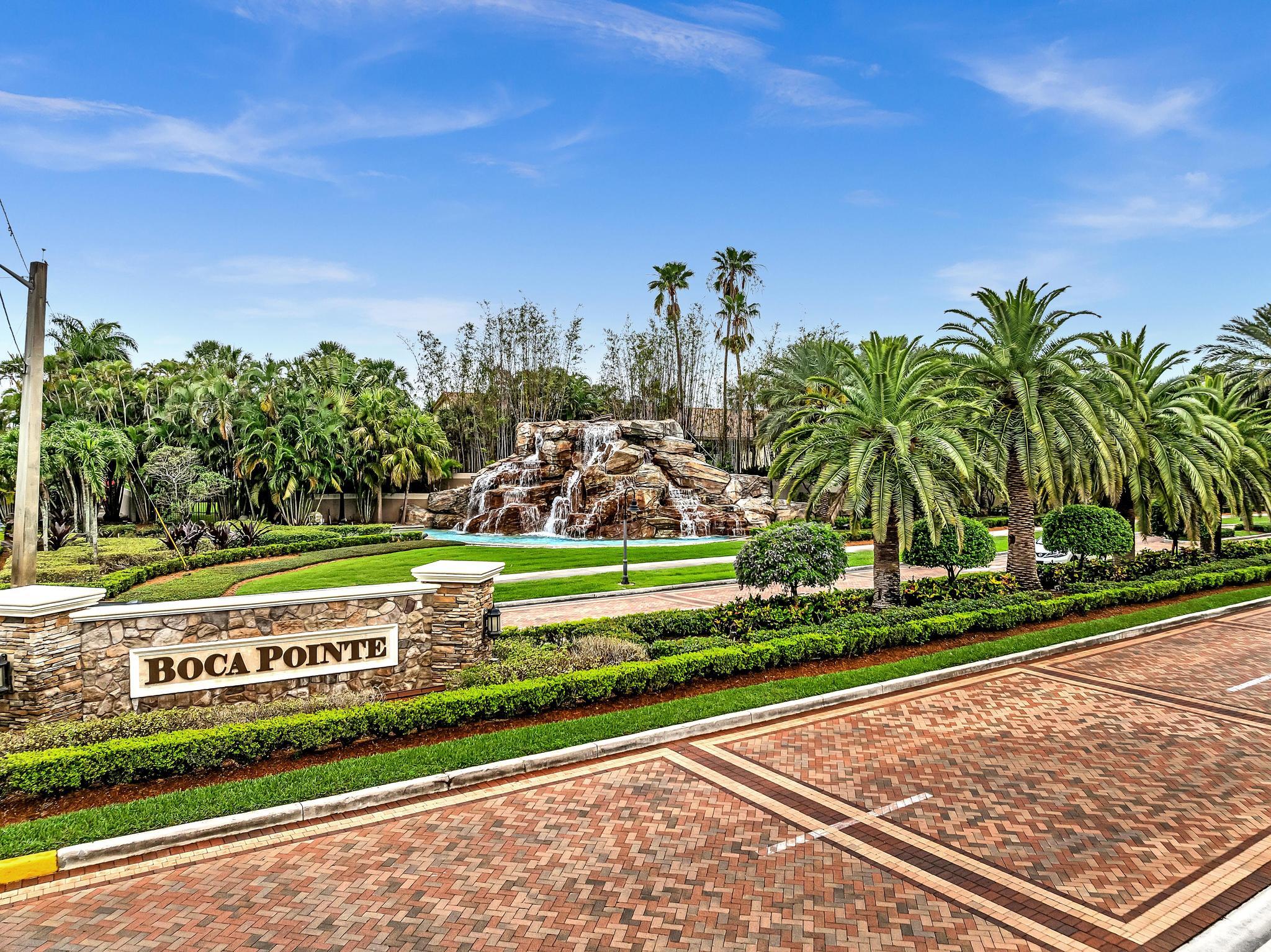 a view of a park with plants and palm trees