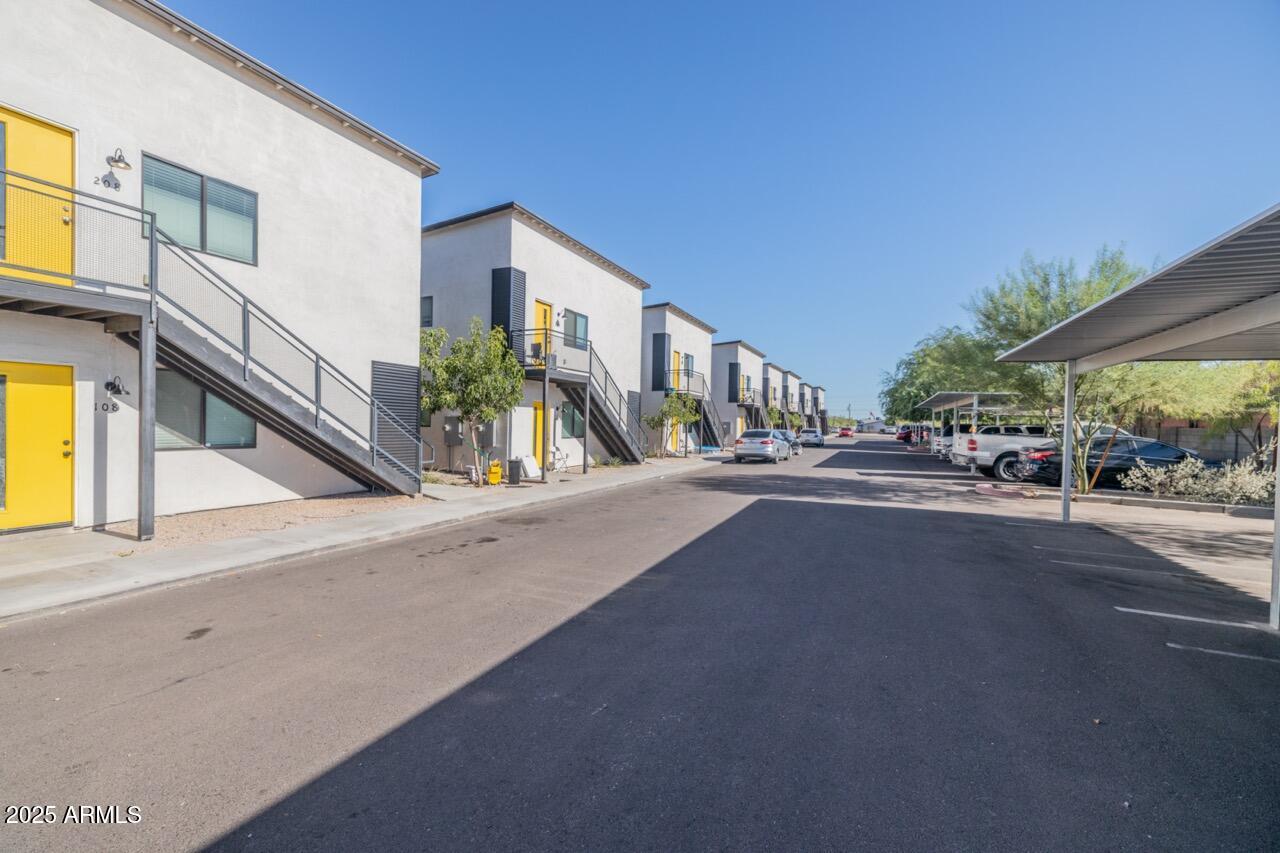 a city view with tall buildings and cars parked on road