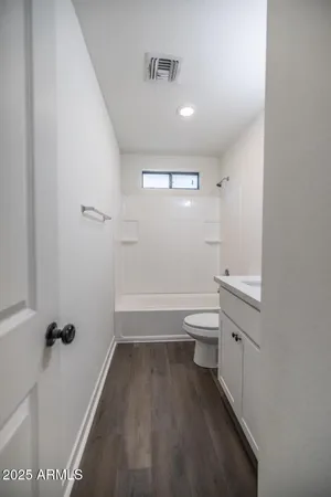 a bathroom with a toilet a sink and bathtub