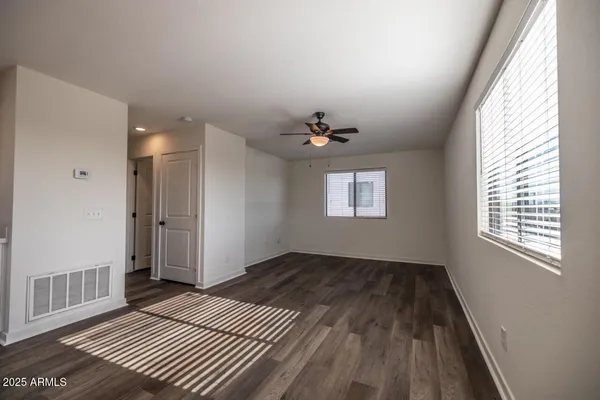 wooden floor in an empty room with a window