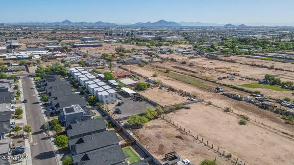 an aerial view of residential houses with outdoor space