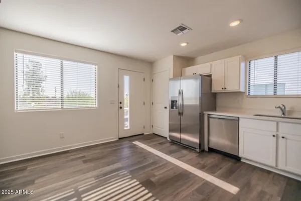 a view of a kitchen with electric appliances and windows