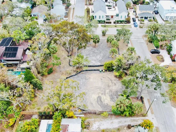 an aerial view of a house with a yard and swimming pool