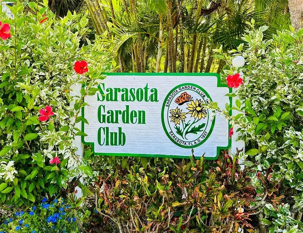 a front view of a building with a garden and garage