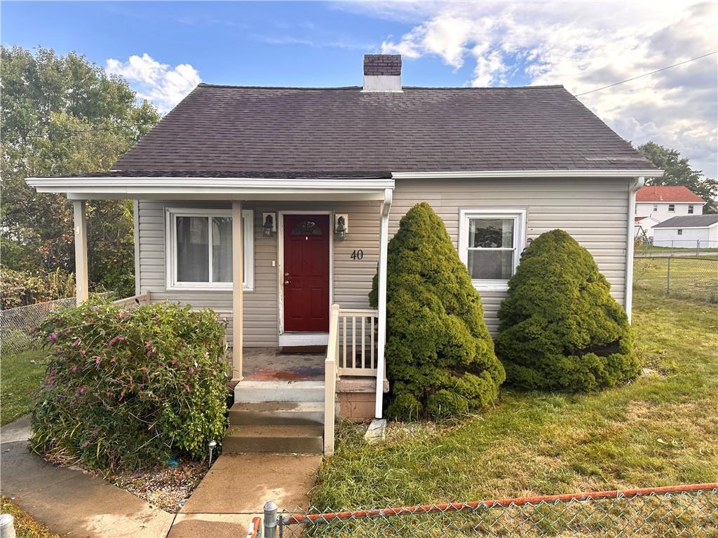 a view of a brick house with plants and large windows