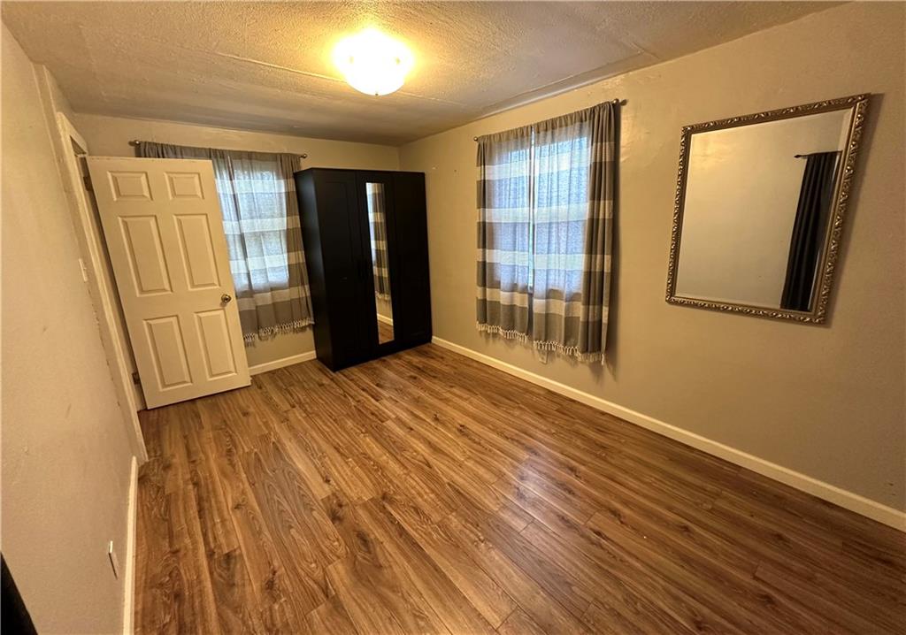 40 2nd Street Lawrence, PA 15055 - Photo 5 of 15 wooden floor in an empty room with a window