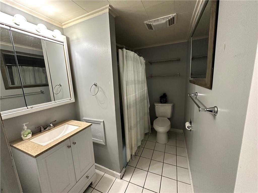 40 2nd Street Lawrence, PA 15055 - Photo 6 of 15 a bathroom with a sink toilet and shower