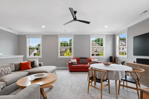 a living room with furniture a window and a flat screen tv
