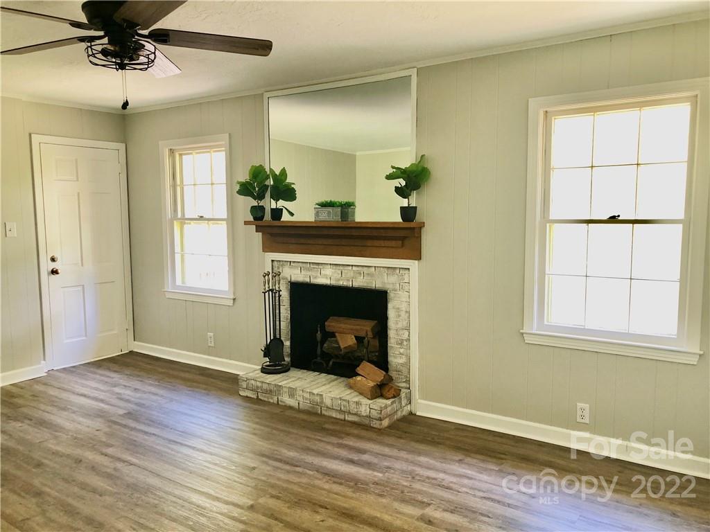 142 Koontz Road Mocksville, NC 27028 - Photo 14 of 47 a living room with a fireplace with wooden floor