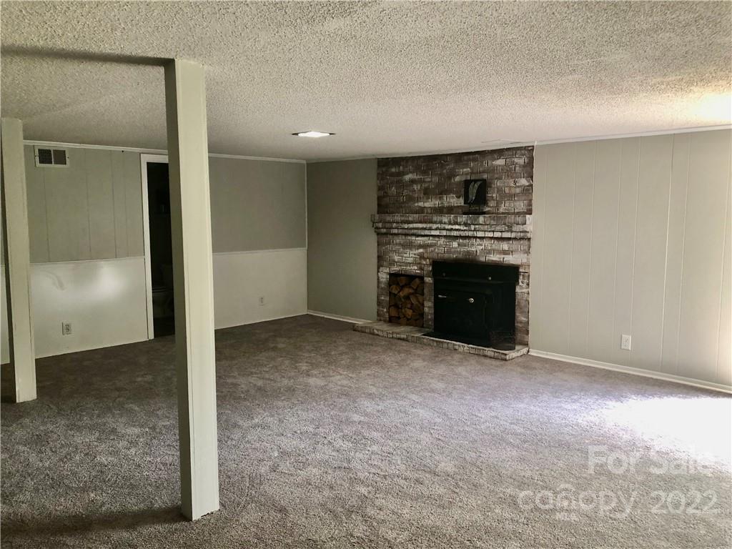 142 Koontz Road Mocksville, NC 27028 - Photo 21 of 47 an empty room with a fireplace
