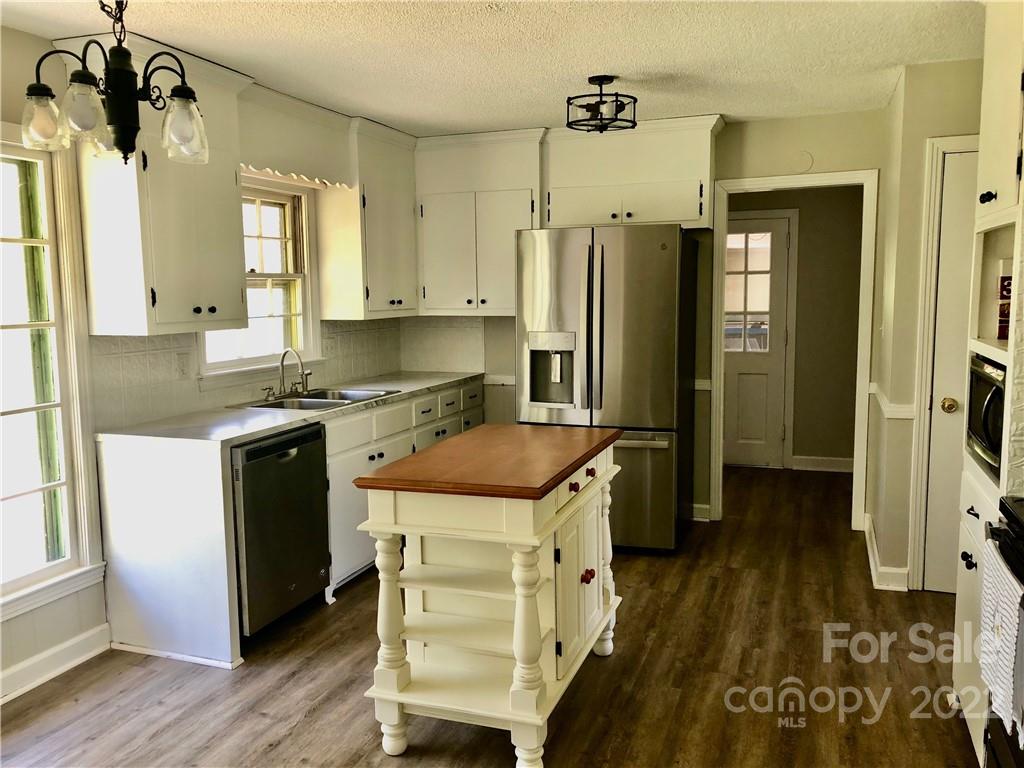 142 Koontz Road Mocksville, NC 27028 - Photo 4 of 47 a kitchen with a refrigerator a sink and wooden floor