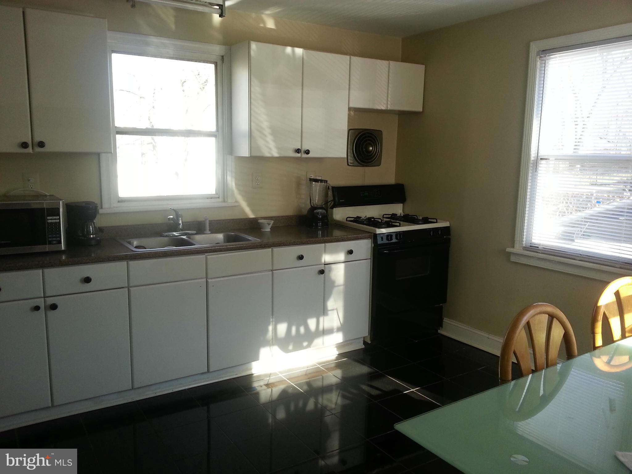 2709 Randolph Road Silver Spring, MD 20902 - Photo 8 of 13 a kitchen with granite countertop a stove a sink and a window