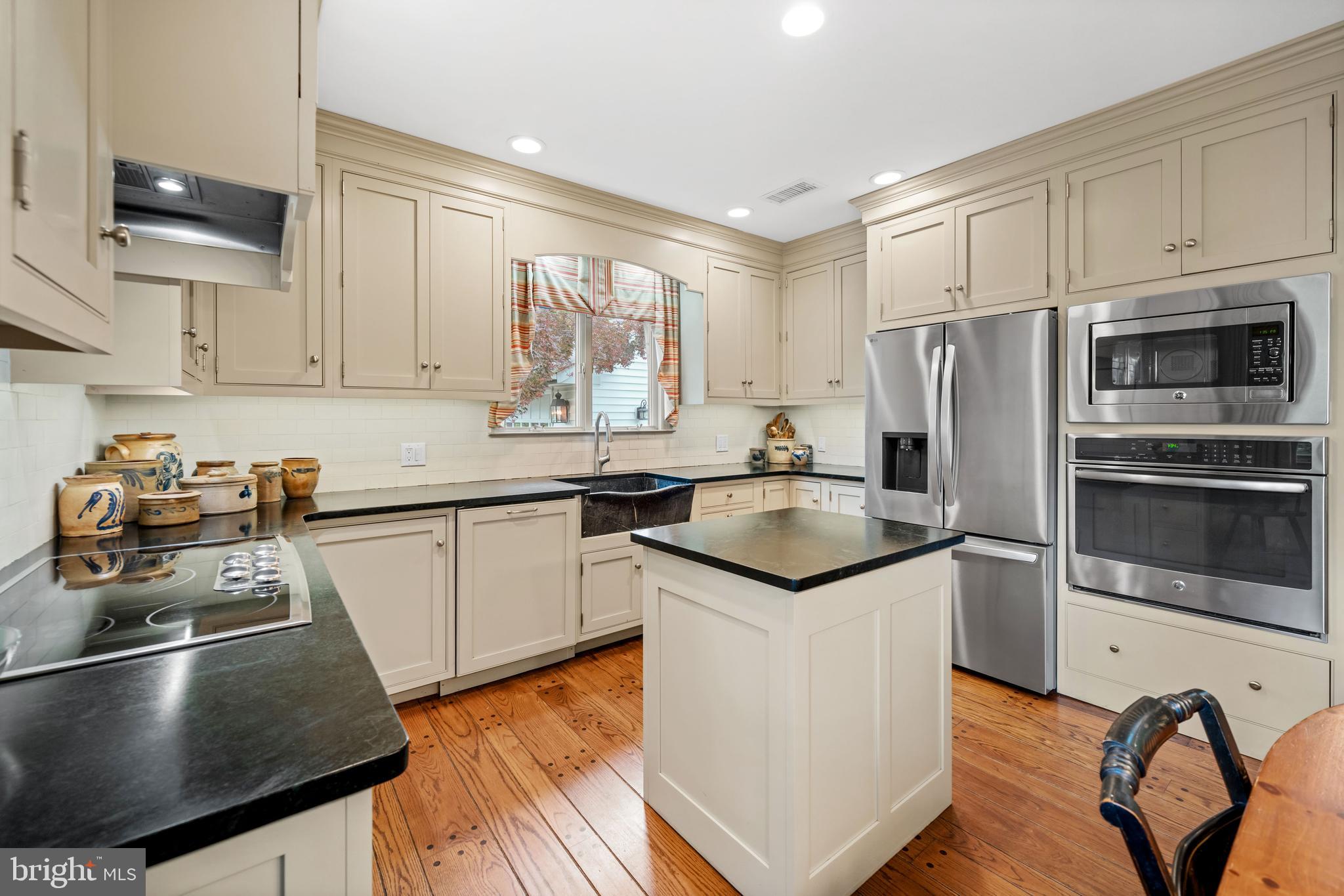 243 Heyburn Road Chadds Ford, PA 19317 - Photo 18 of 58 a kitchen with granite countertop a sink stainless steel appliances and white cabinets