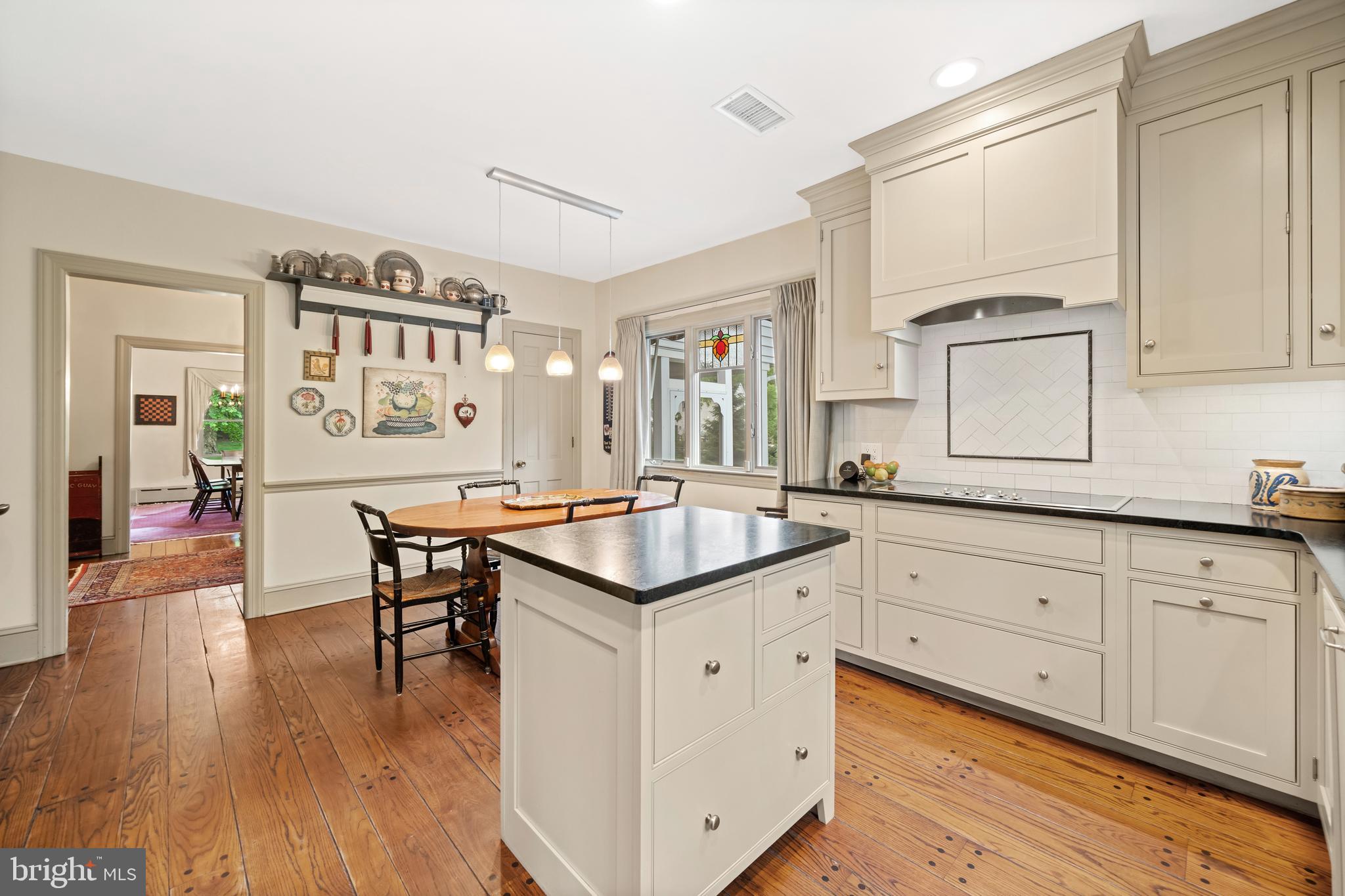 243 Heyburn Road Chadds Ford, PA 19317 - Photo 21 of 58 a kitchen with granite countertop a sink cabinets and wooden floor