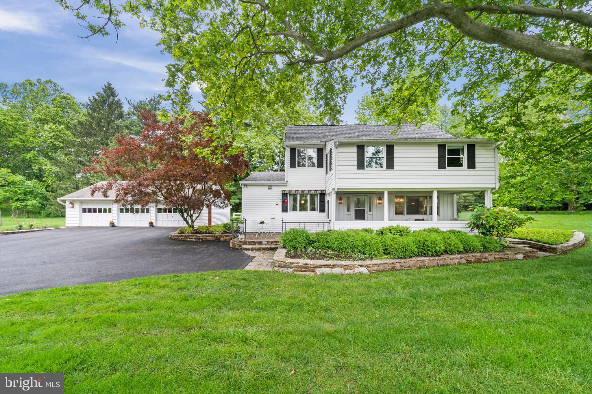 243 Heyburn Road Chadds Ford, PA 19317 - Photo 3 of 58 a front view of a house with a garden