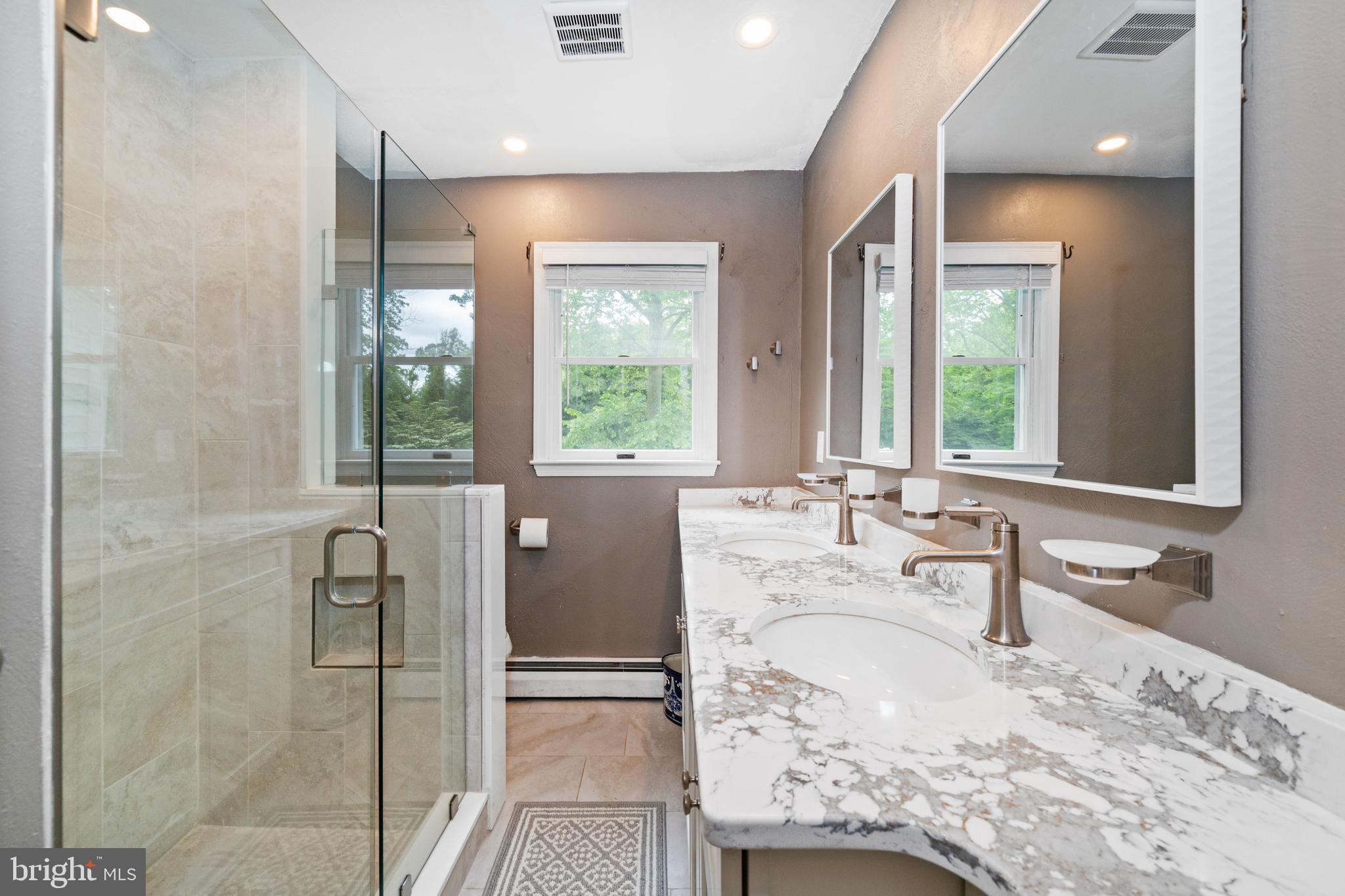 243 Heyburn Road Chadds Ford, PA 19317 - Photo 36 of 58 a bathroom with a granite countertop sink mirror and a shower