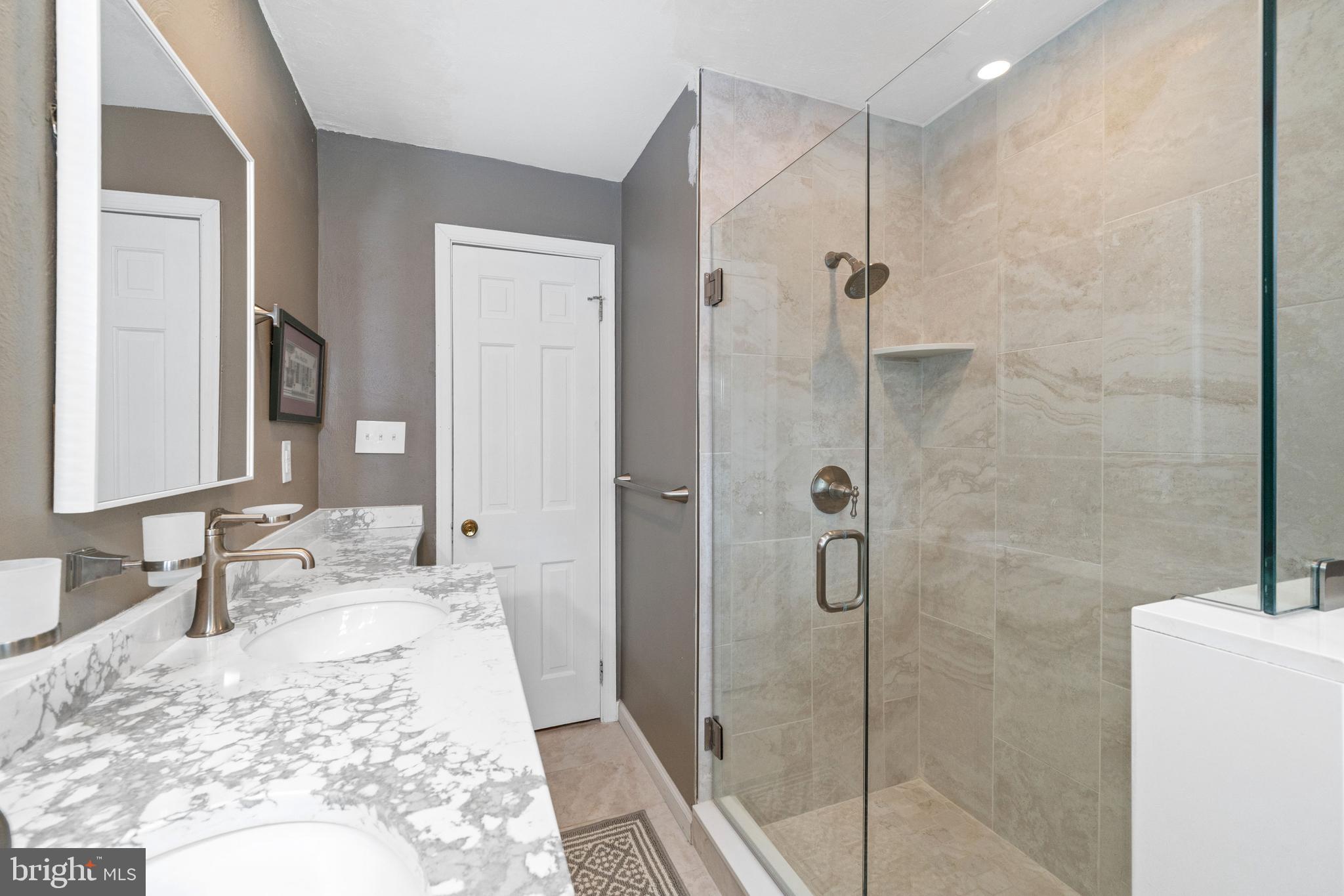 243 Heyburn Road Chadds Ford, PA 19317 - Photo 37 of 58 a bathroom with a granite countertop sink mirror and shower