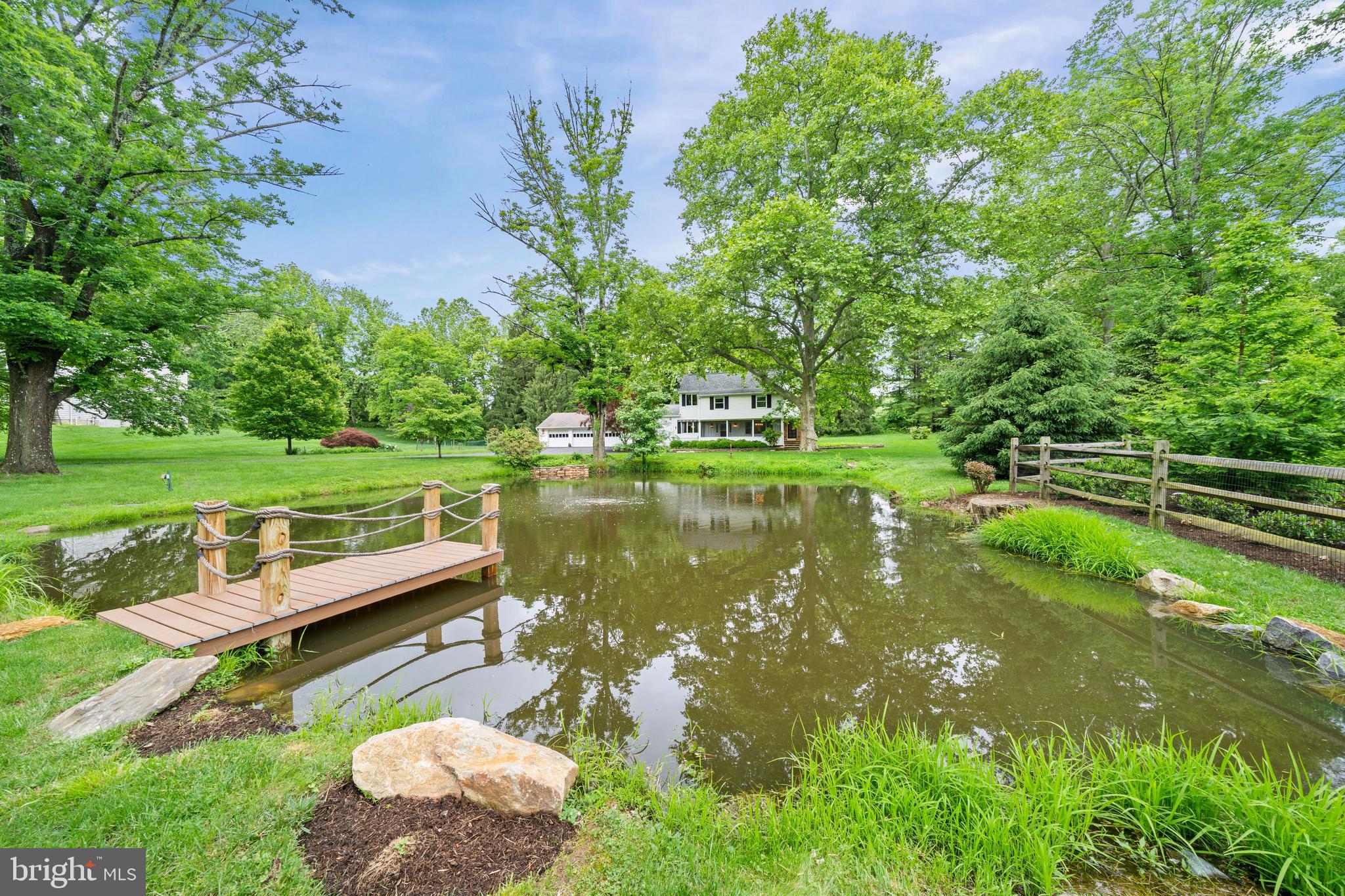 243 Heyburn Road Chadds Ford, PA 19317 - Photo 53 of 58 a view of a lake with a yard and a wooden fence