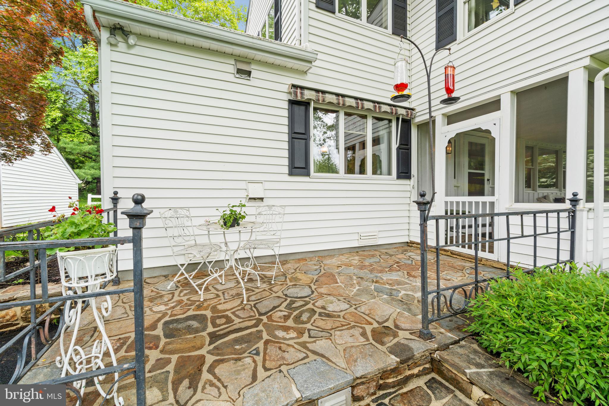 243 Heyburn Road Chadds Ford, PA 19317 - Photo 8 of 58 a view of a white house with a potted plant and a table and chair