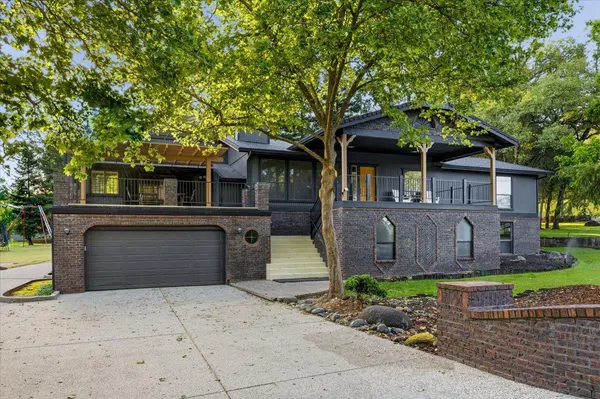 a front view of a house with a garden
