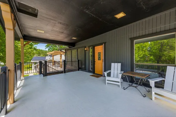 a view of a house with backyard and sitting area