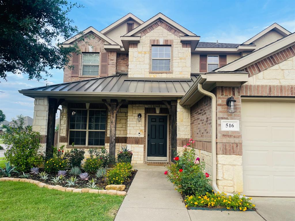 516 Angela Lane Euless, TX 76039 - Photo 2 of 39 Craftsman-style home with stone siding, an attached garage, a metal roof, and a standing seam roof
