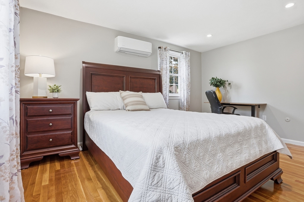 33 Simon Willard Road Acton, MA 01720 - Photo 18 of 42 a bedroom with a bed and a lamp on dresser