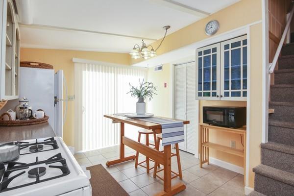 21 Grove Street-onset Wareham Ma Onset, MA 02558 - Photo 5 of 15 a kitchen with stainless steel appliances a stove a chimney a dining table and chairs