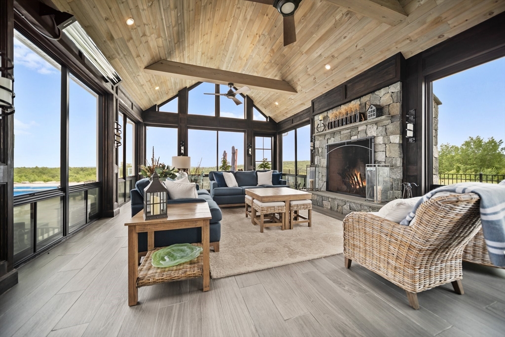 17 Chestnut Lane Littleton, MA 01460 - Photo 13 of 40 a living room with furniture a fireplace and a floor to ceiling window